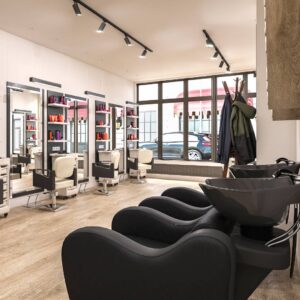 A newly updated beauty salon with practical interior design finishes such as leather chairs and modern lighting.