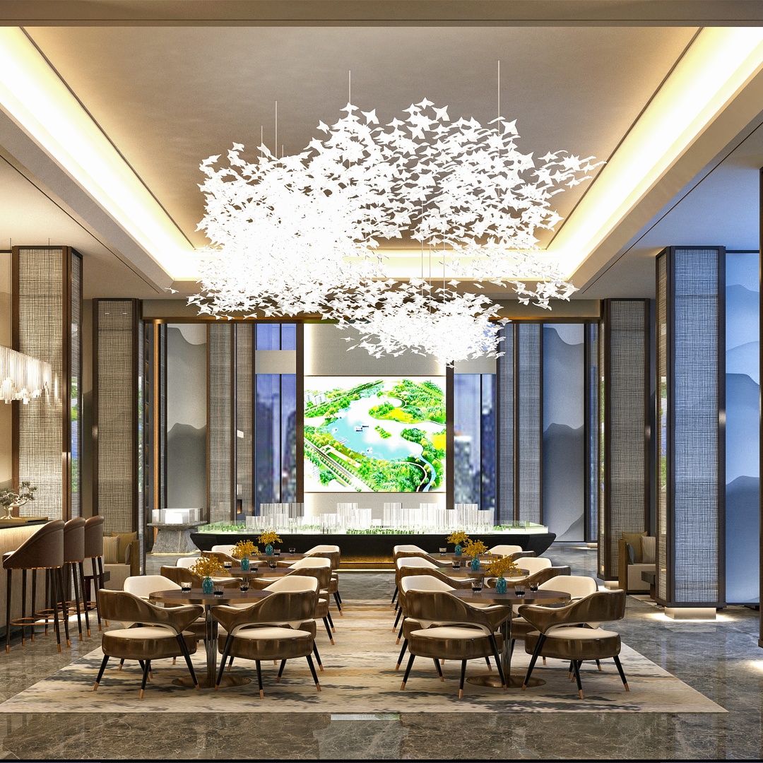 The lobby of a luxury hotel is furnished with a variety of comfortable chairs. A bright chandelier hangs from the ceiling.
